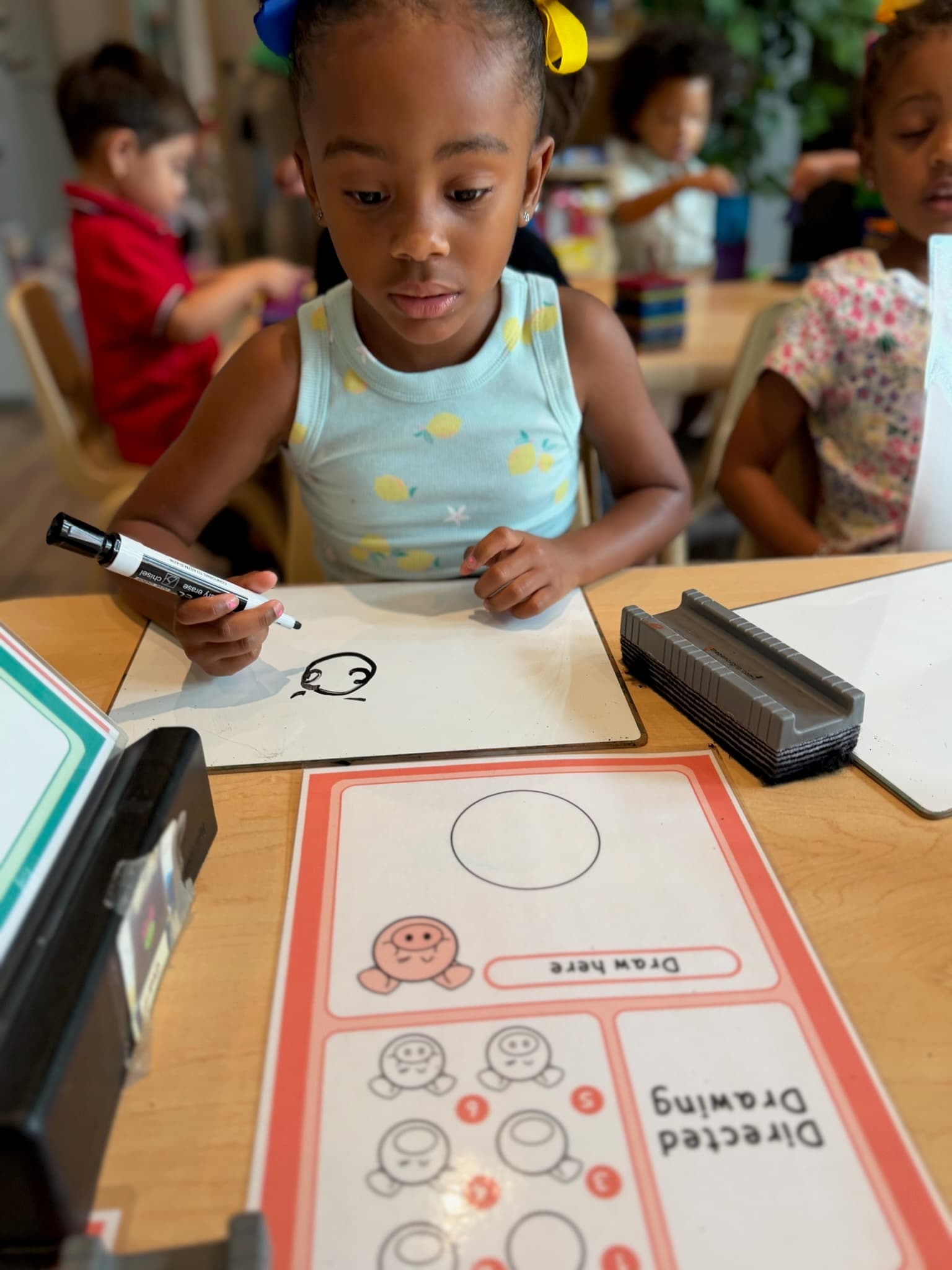 Pre-K child engaged in a classroom writing activity