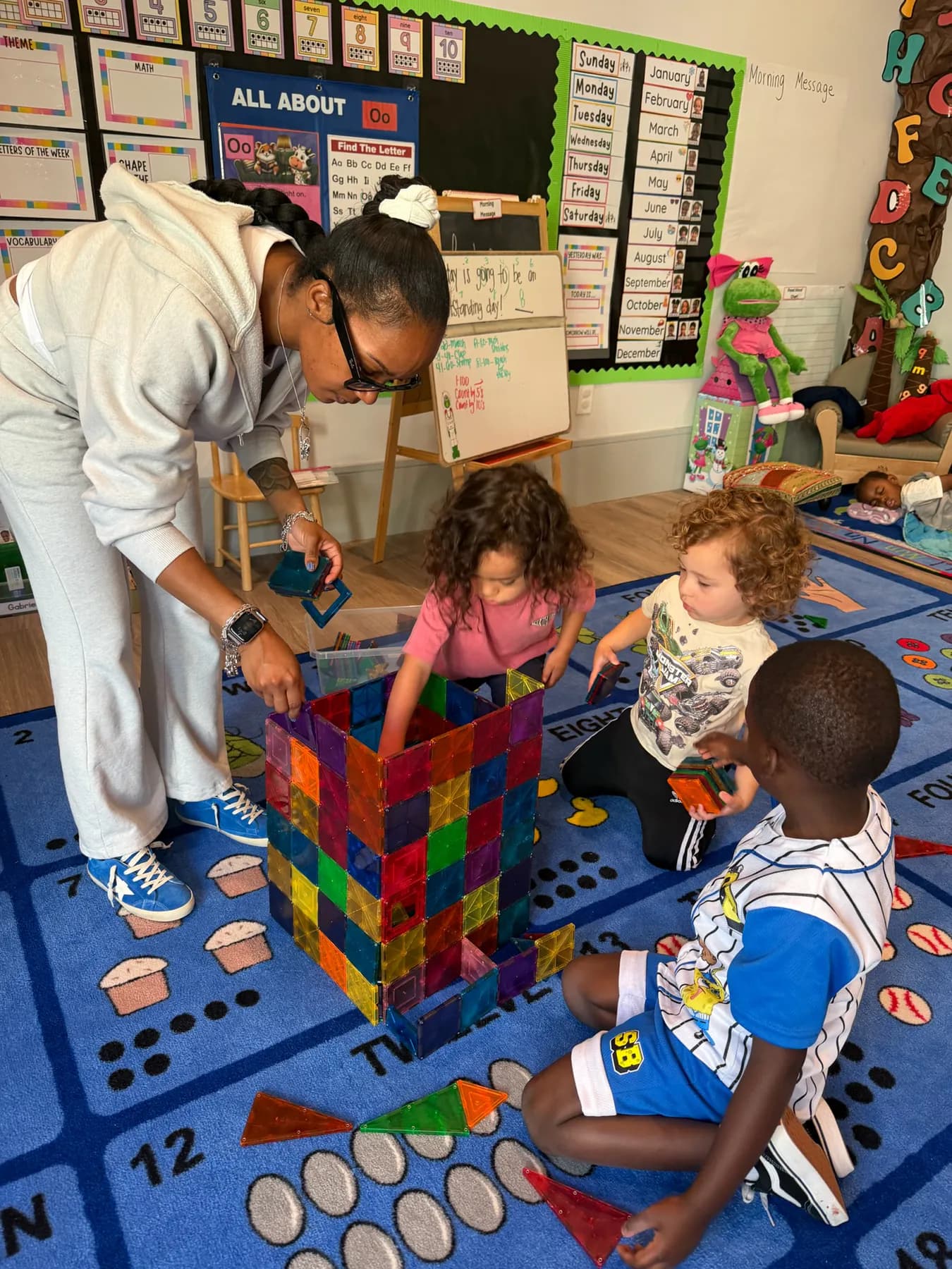 Teacher guiding children through a hands-on enrichment activity