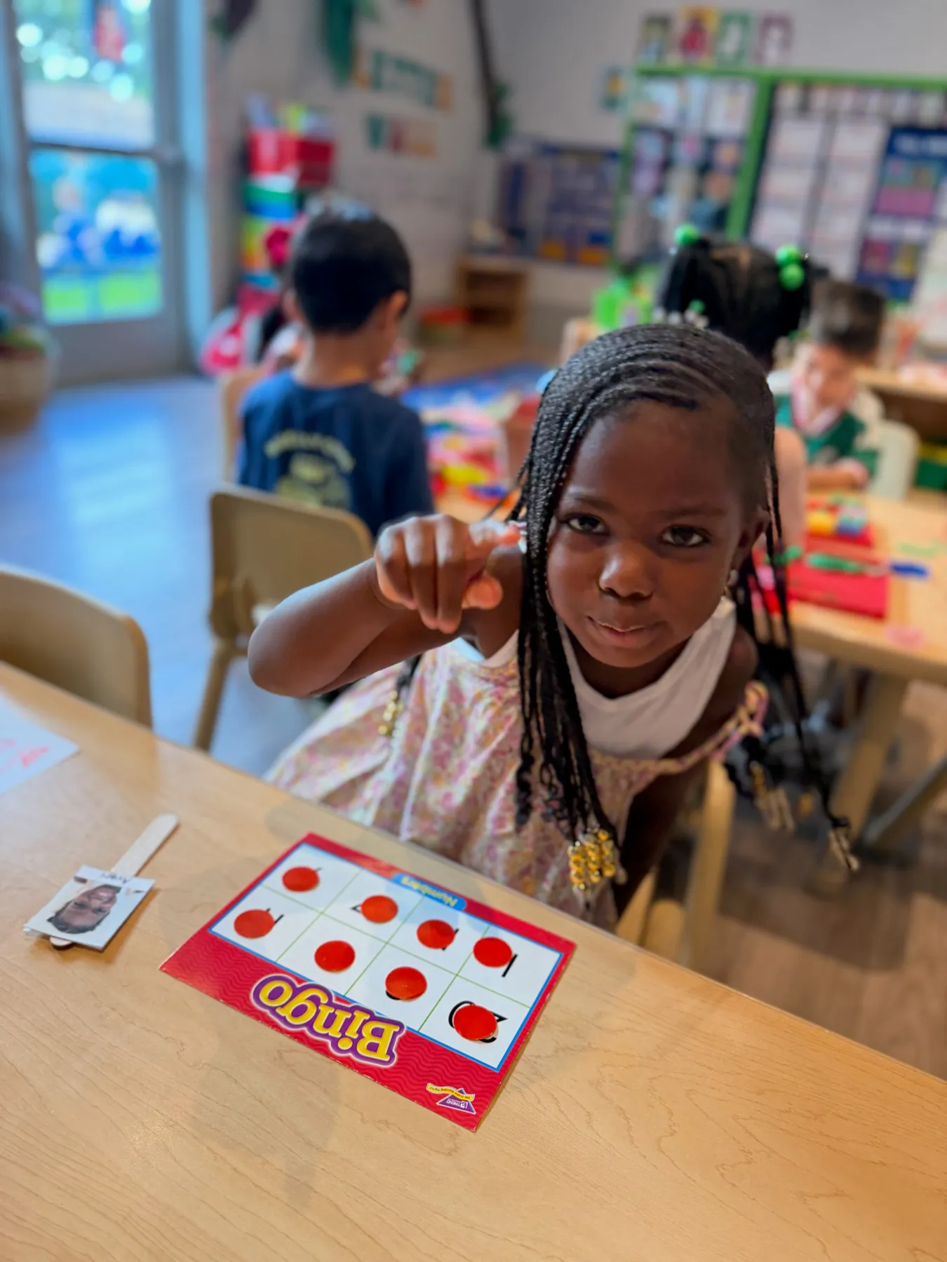 Child proudly participating in a school-readiness activity