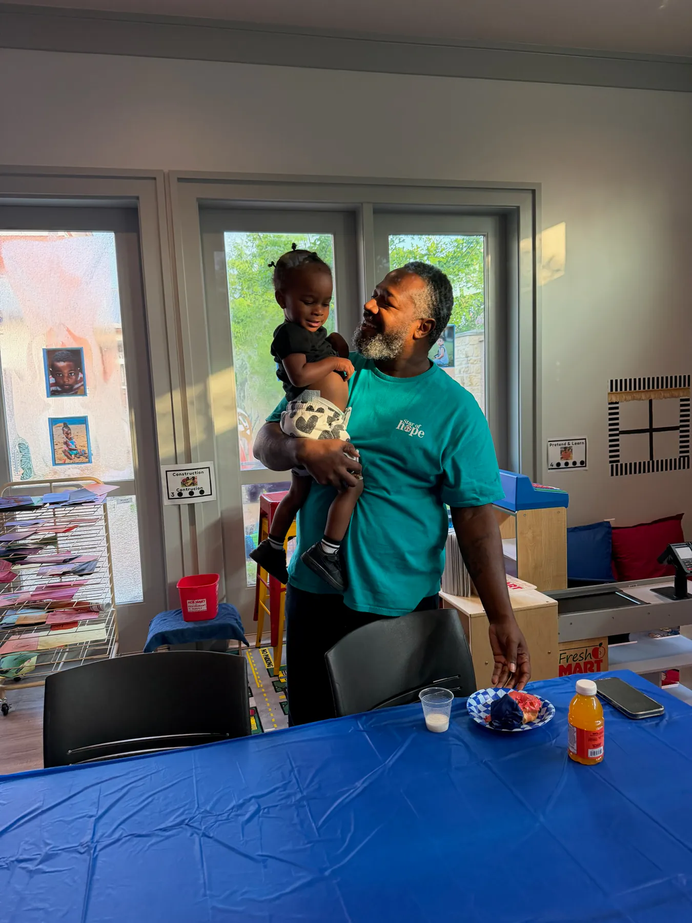 Father sharing a joyful school moment with his child