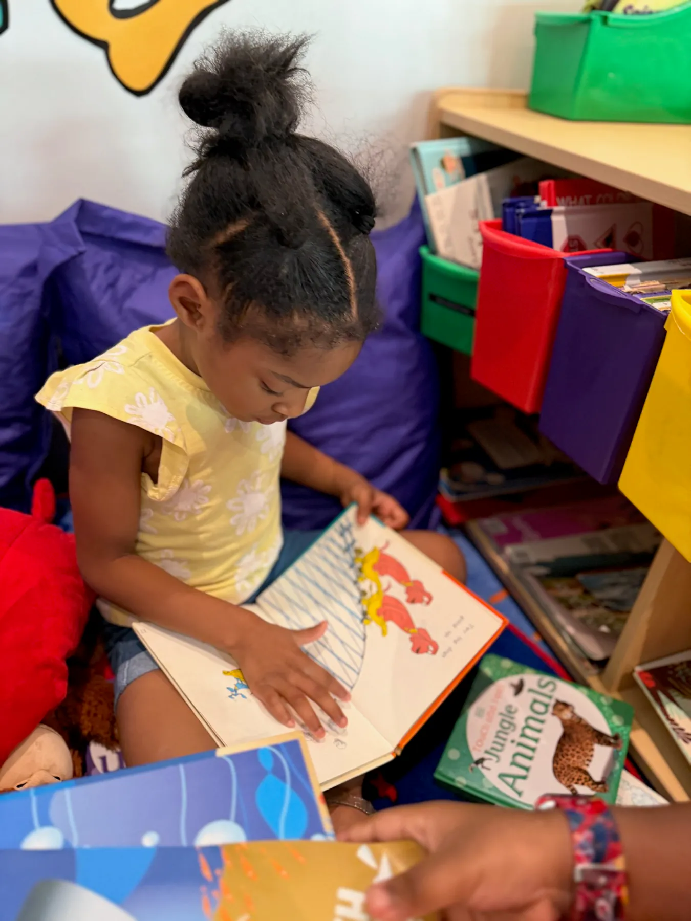 Visionaries student independently exploring a classroom book