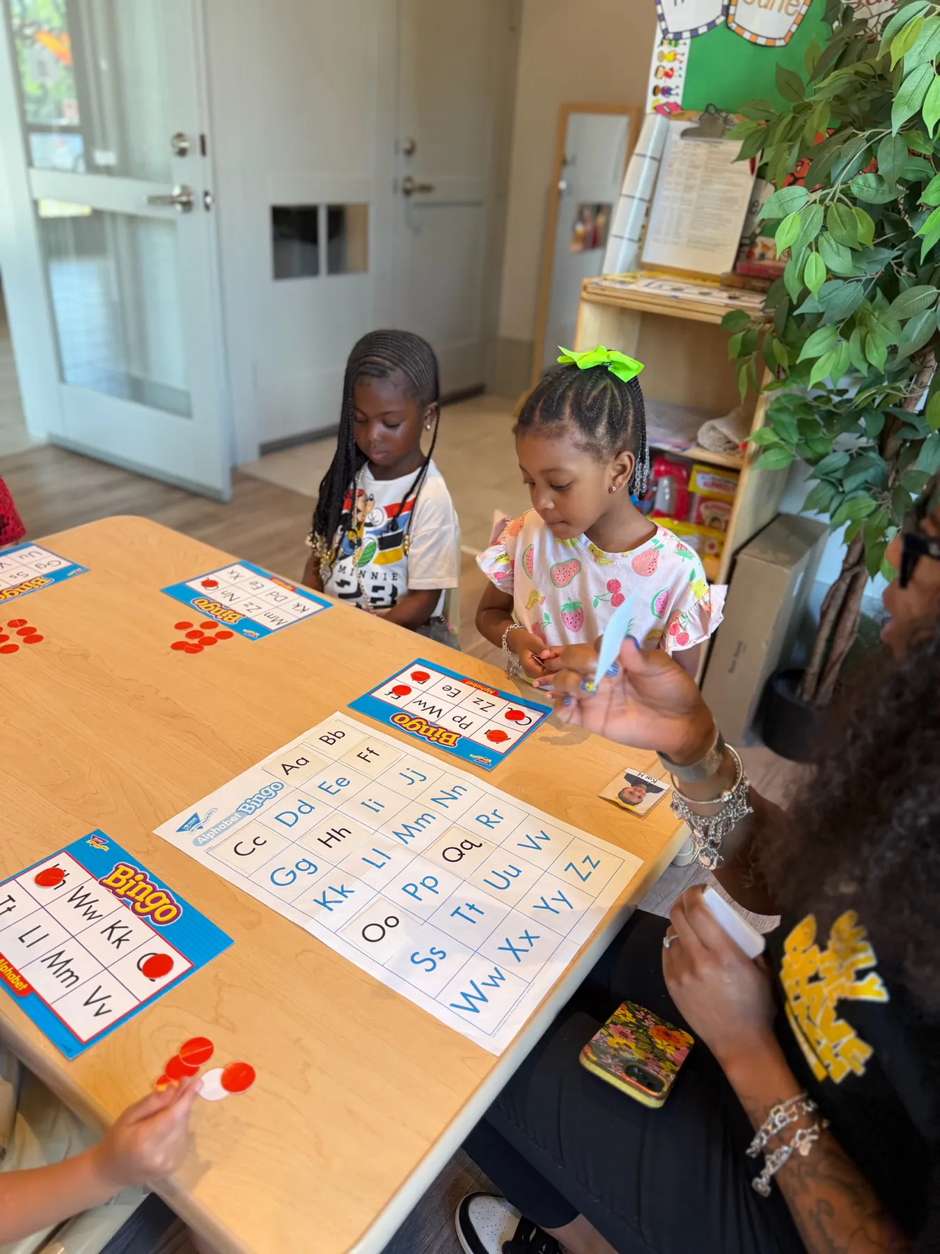 Visionaries students practicing early literacy with their teacher at Regency
