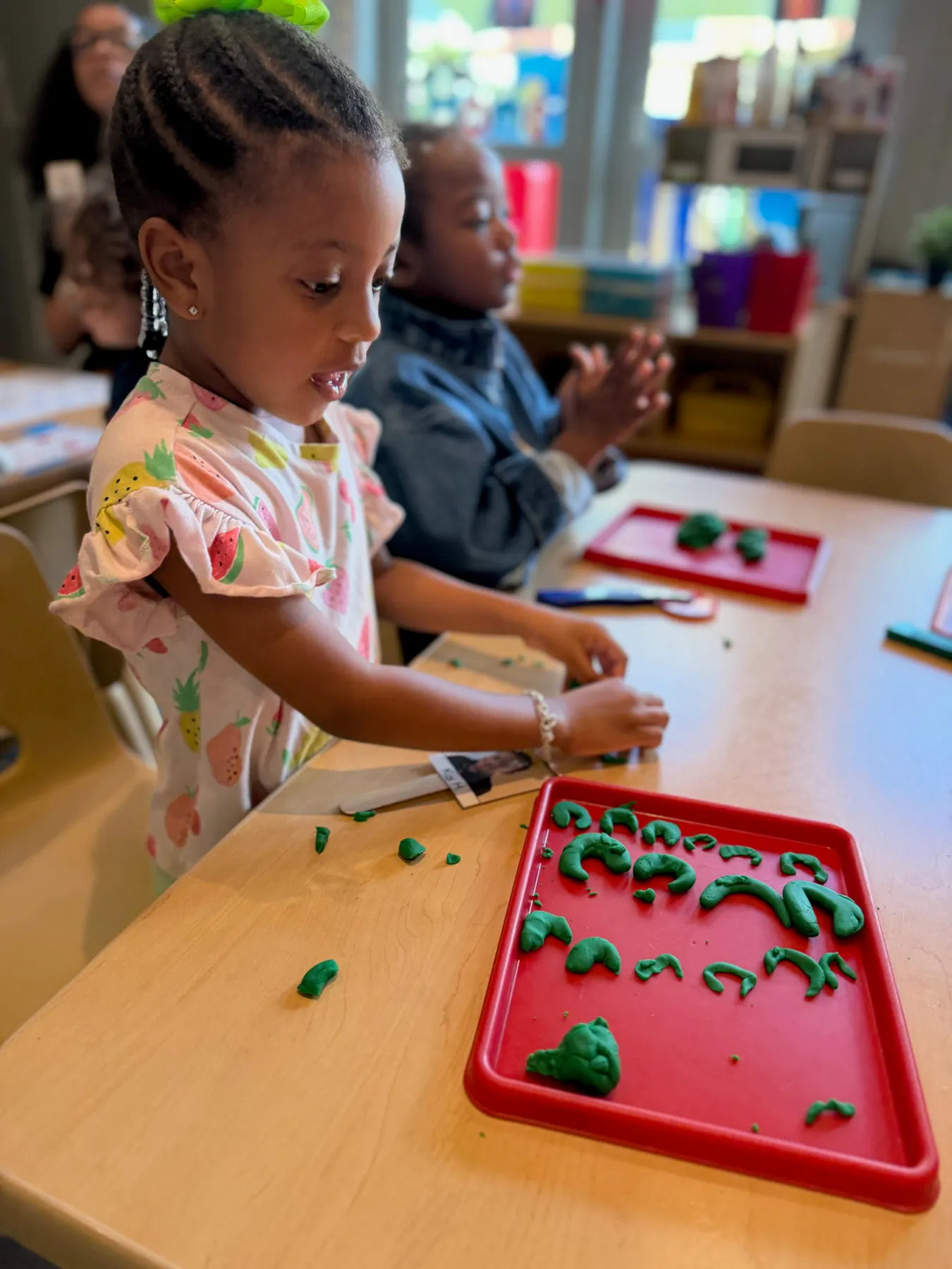 Visionaries student forming letters with hands-on classroom materials